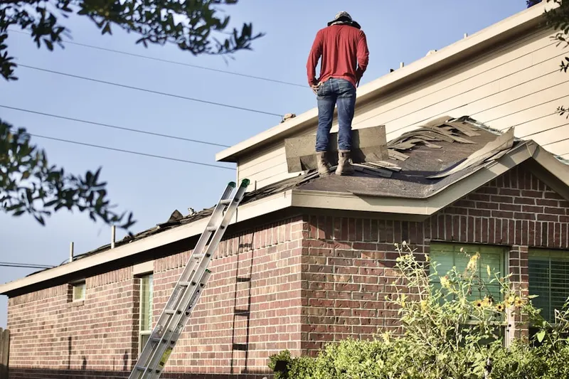 Professional roofer working on a residential roof in Mystic River